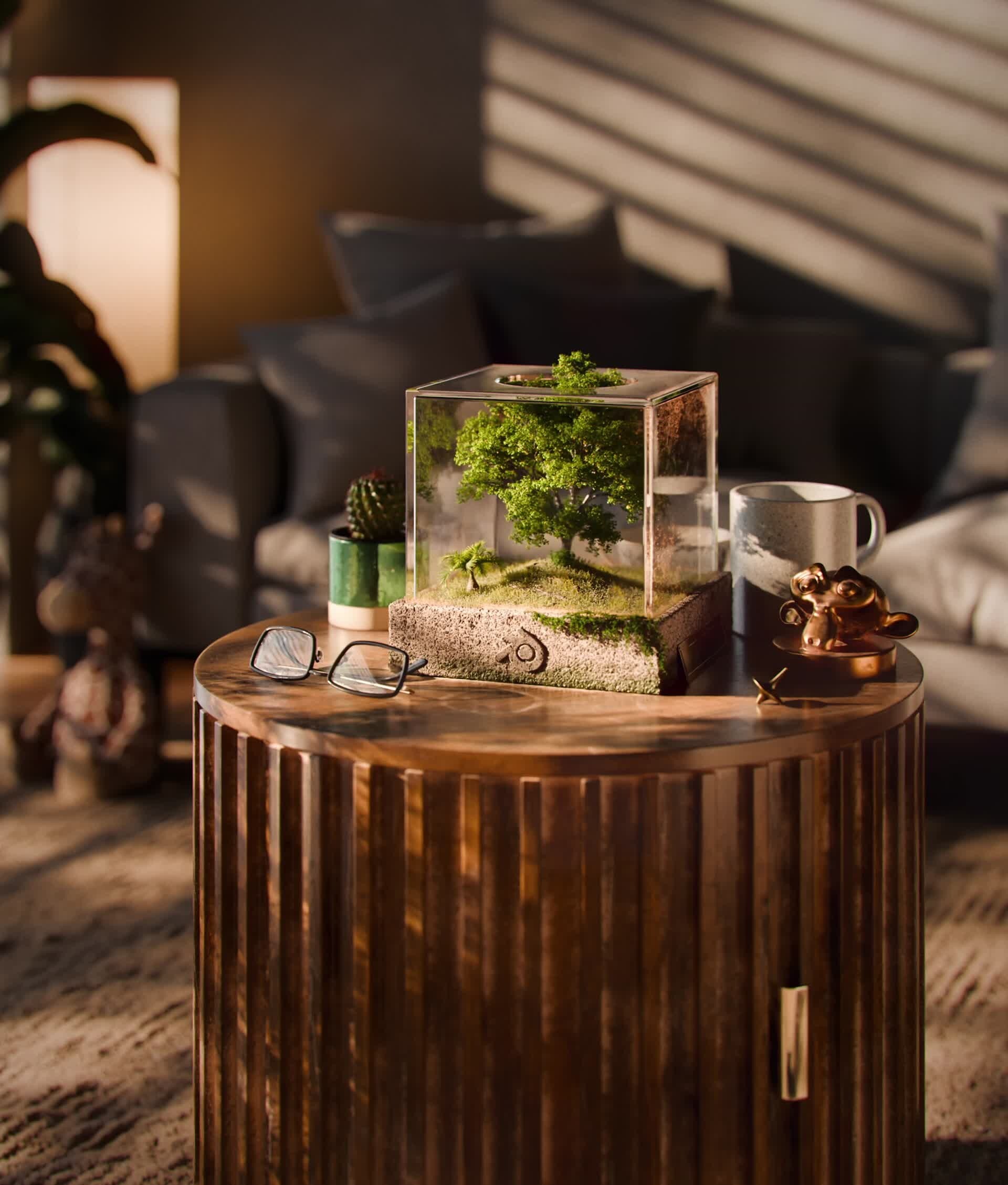 The Default Cube: a miniature landscape inside a transparent cube on a wooden table in a sunlit interior.